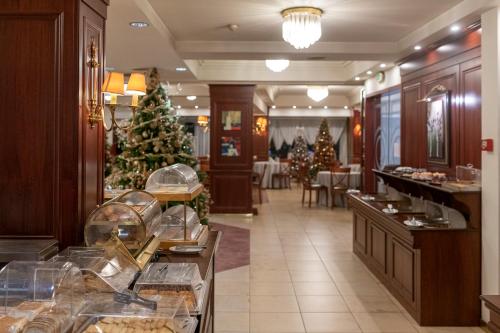 a bakery with christmas trees in the middle of a room at Lingos Hotel in Florina