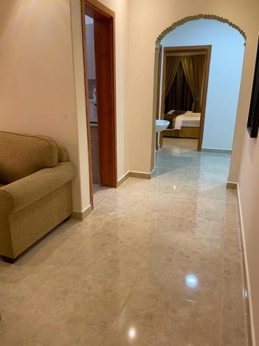 a living room with a couch and a bedroom at روح الأصيلة للشقق المخدومة Roh Alaseilah Serviced Apartments in Taif