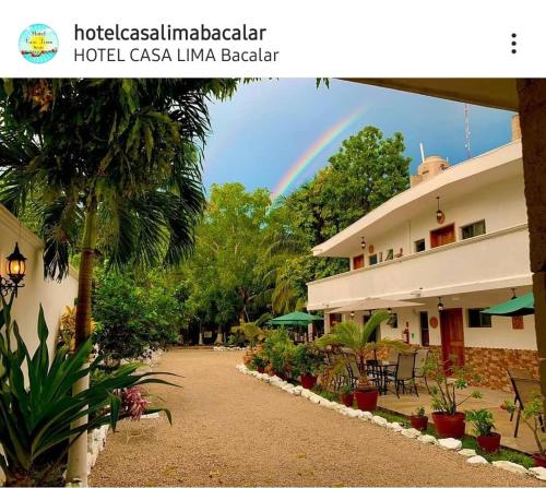 a rainbow in the sky above a hotelgc lianaiane beach at Hotel Casa Lima Bacalar in Bacalar