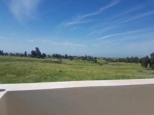 a view of a green field from a window at קשת לכנרת in Keshet