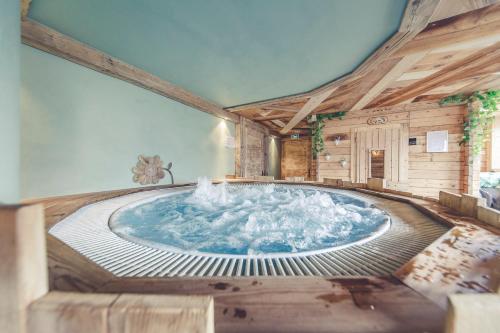 a large plunge pool in a room with at Le Marie Lydie - Chambre d'hôte in La Chapelle-dʼAbondance