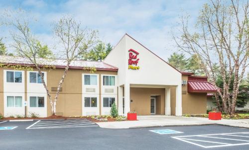 a hotel exterior with a parking lot at Red Roof Inn PLUS+ South Deerfield - Amherst in South Deerfield