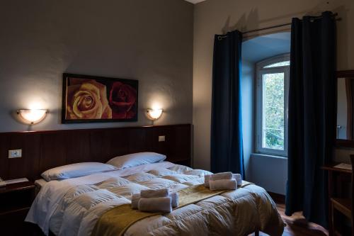 a bedroom with a bed with two towels on it at Antica Terrazza Frascati in Frascati