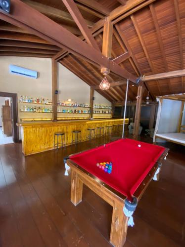 a red pool table in a room with a bar at WINNER BEACH HOTEL in Juréia
