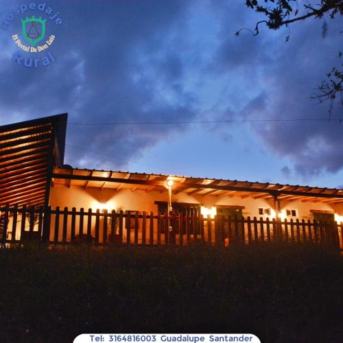 a house with a fence in front of it at night at El Portal De Don Luis in Guadalupe