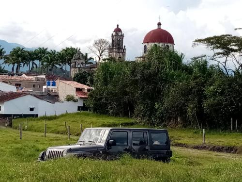 a truck parked in the grass in a field at El Portal De Don Luis in Guadalupe