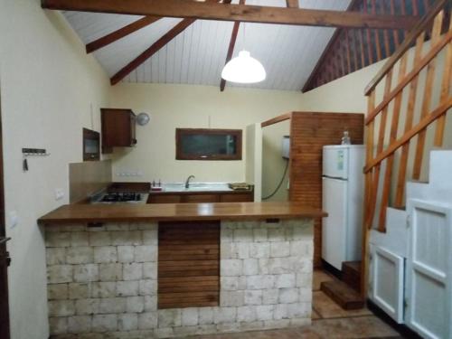 a kitchen with a sink and a refrigerator in a room at Villa Nature in Toliara