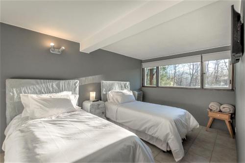 a bedroom with two beds and a window at ÑireBosque, casas de pueblo in Villa La Angostura