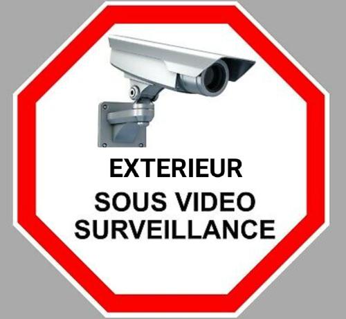 a red and white sign with a surveillance camera at SW Cosy Apart - Chambly Persan Roissy in Persan