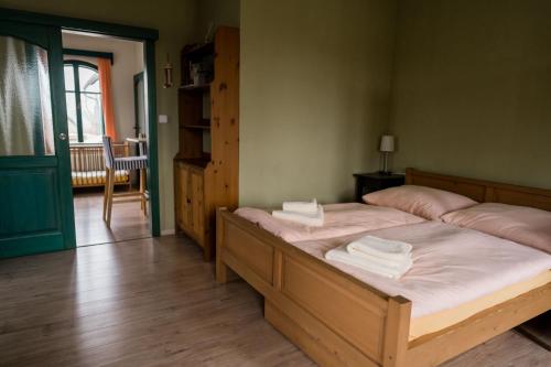 a bedroom with a bed with two towels on it at Na Kopečku AD 1795 - penzion s restaurací a wellness v Podkrkonoší in Dvůr Králové nad Labem