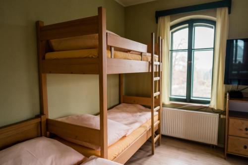 two bunk beds in a room with a window at Na Kopečku AD 1795 - penzion s restaurací a wellness v Podkrkonoší in Dvůr Králové nad Labem