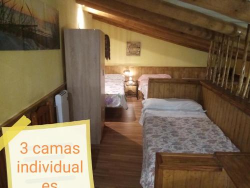 a room with two beds and a sign that says individual as at LA MANDUCA in Teruel
