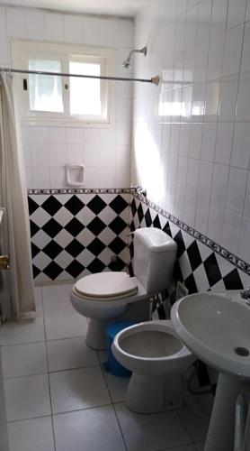 a bathroom with a toilet and a sink at Casa Azul in Maldonado