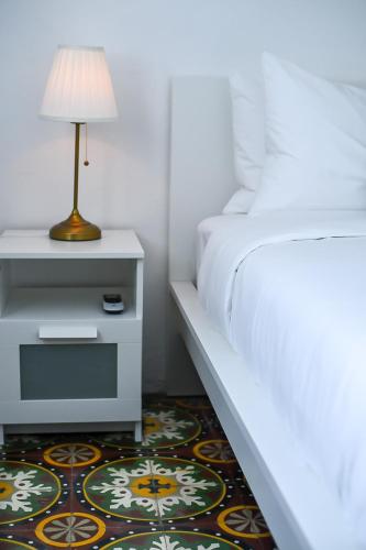 a bedroom with a bed and a table with a lamp at Digital Nomad San Agustin Apartments in San Juan