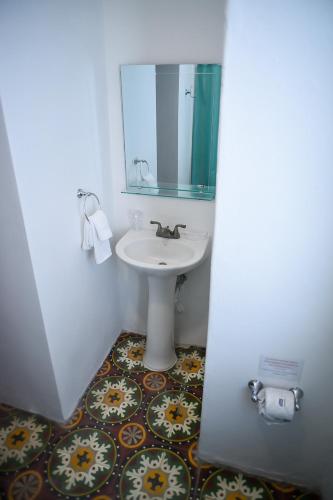 a bathroom with a sink and a mirror at Digital Nomad San Agustin Apartments in San Juan