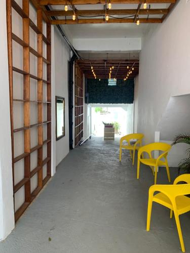 a hallway with yellow tables and chairs in a building at Digital Nomad San Agustin Apartments in San Juan
