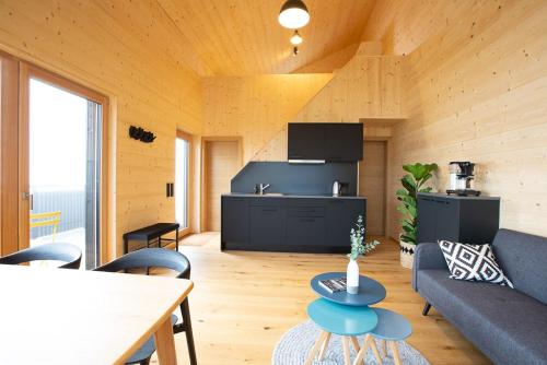 a living room with a couch and a table at Masura Cabins in Bürserberg