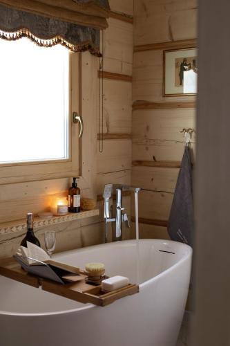 a white tub in a bathroom with a window at Tatra Chalet Krupówki 77A in Zakopane
