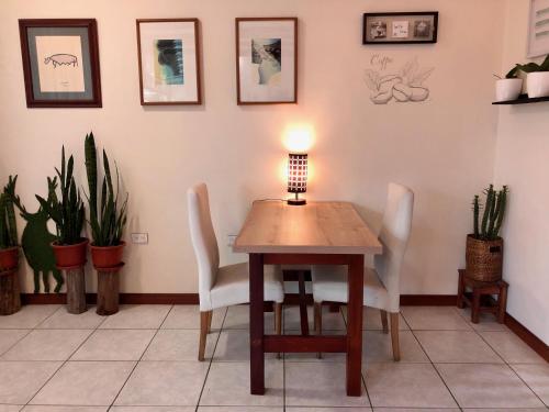 a table with chairs and a lamp on top of it at Quito Terrace in Quito