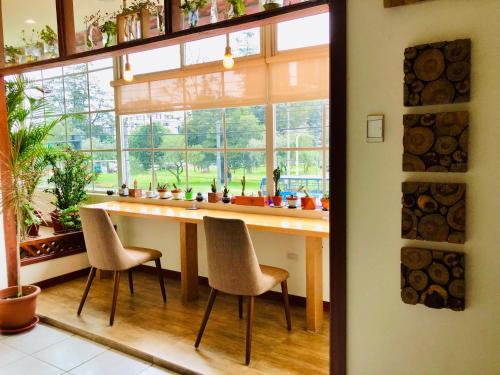 a kitchen with a table and chairs in front of a window at Quito Terrace in Quito