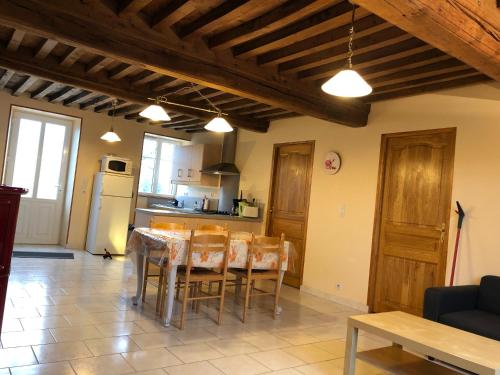 a kitchen and dining room with a table and chairs at Gîte du Morvan in Saint-Germain-des-Champs