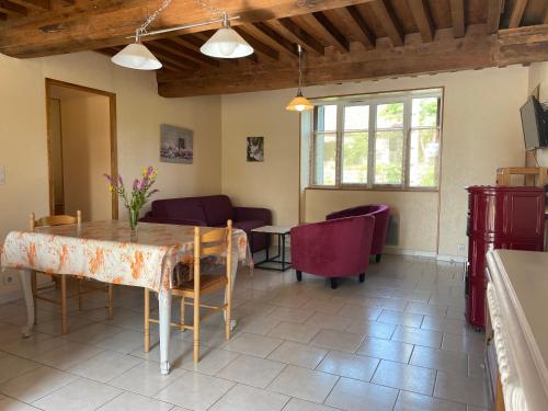 a living room with a table and chairs at Gîte du Morvan in Saint-Germain-des-Champs