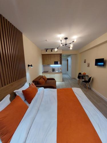 a bedroom with a large bed and a living room at New Gudauri Redco TWINS-Premium Mountain Apartment Close The Gondola lift in Gudauri