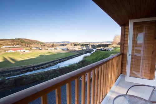 a balcony with a view of a river at Guesthouse Fludir - Grund in Fludir