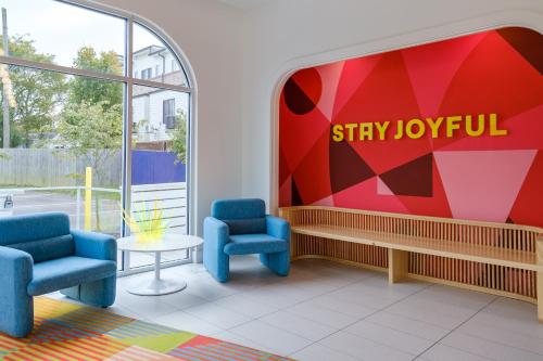 a lobby with two chairs and a sign that reads stay joyful at The Gallatin in Nashville