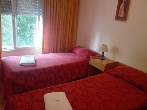 a bedroom with two beds and a window at Bet Hotel Buenos Aires in Buenos Aires
