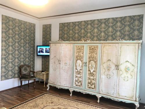 a living room with a large cabinet and a chair at Lambach Villa Appartament 2 in Mürzzuschlag