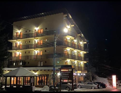 a large building with cars parked in front of it at Hotel Restaurant Alessia in Ranca