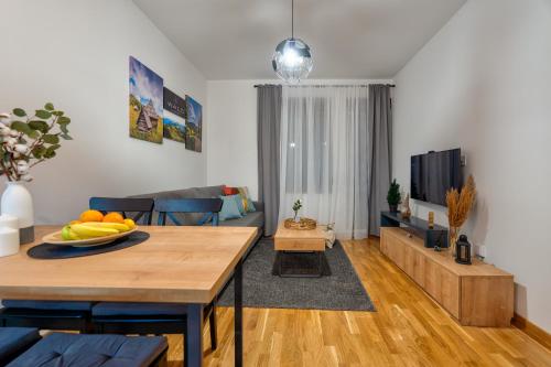 a living room with a table and a couch at WALD Apartmani&SPA in Zlatibor