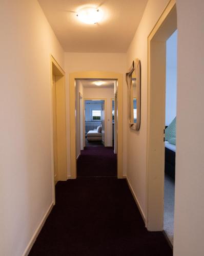 a hallway leading into a hotel room with a hallway leading to a bedroom at Landhaus am Itterbach Willingen in Willingen