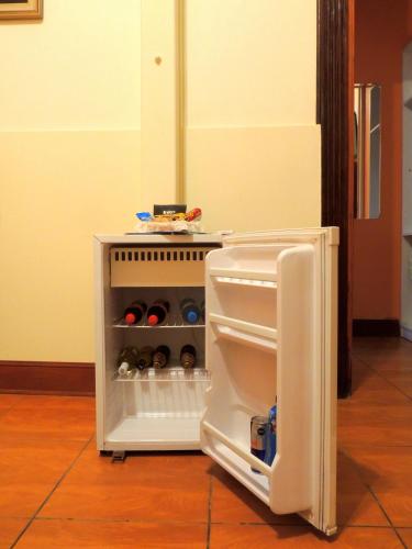 an open refrigerator with its door open with drinks inside at Lima Wari Hotel Boutique in Lima