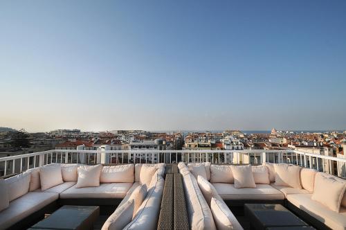a white couch sitting on top of a balcony at Splendid Hotel & Spa Nice in Nice