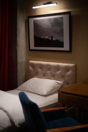 a bedroom with a bed and a picture on the wall at Ati Ambavi Botique Hotel Gudauri in Gudauri