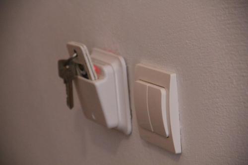 a white holder on the side of a wall at Hotel Stavris in Khóra Sfakíon