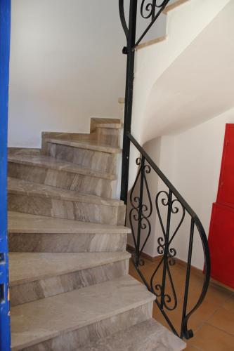 a set of stairs with a metal railing at Hotel Stavris in Khóra Sfakíon