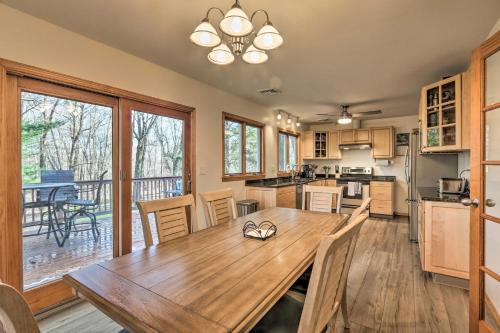 a large kitchen with a wooden table and a dining room at Family-Friendly Woodbury Home with Yard and Deck! in Woodbury