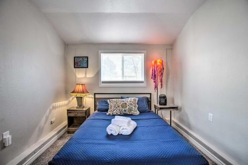 a bedroom with a blue bed with towels on it at Centrally Located Aurora Home w/ Covered Patio in Aurora