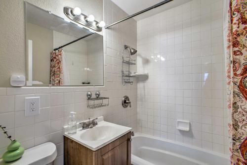 a bathroom with a sink and a tub and a mirror at Centrally Located Aurora Home w/ Covered Patio in Aurora