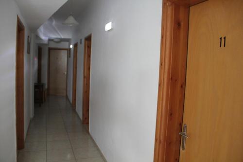 an empty hallway with a row of doors and a hallway at Hotel Stavris in Khóra Sfakíon