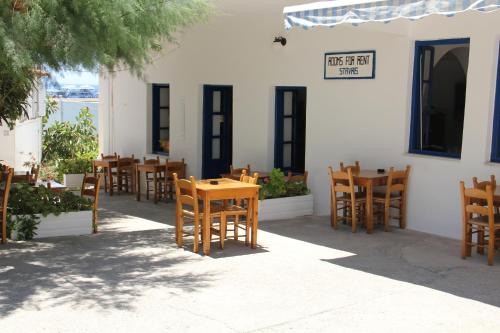 a group of tables and chairs outside of a restaurant at Hotel Stavris in Khóra Sfakíon