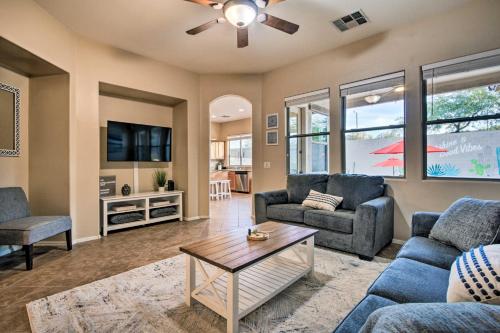 a living room with two couches and a tv at Pool and Game Room Home in Goodyear Near Golfing in Liberty