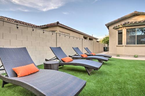a row of chairs sitting on a lawn at Pool and Game Room Home in Goodyear Near Golfing in Liberty