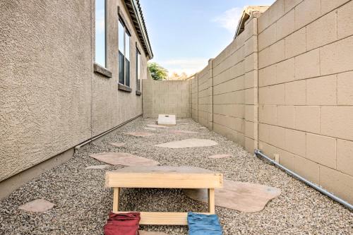 a bench sitting on the ground next to a wall at Pool and Game Room Home in Goodyear Near Golfing in Liberty