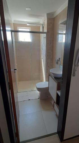 uma casa de banho com um chuveiro, um WC e um lavatório. em Apartamento Inteiro jardim Iririú em Joinville