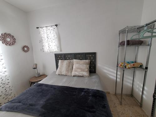 a bedroom with a bed and a metal bunk bed at Aguadilla Surfers Lair apt with electricity water AC Wifi 8 minute walk to Crashboat beach in Aguadilla