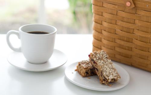 a piece of cake on a plate next to a cup of coffee at Inns of Aurora Resort & Spa in Aurora